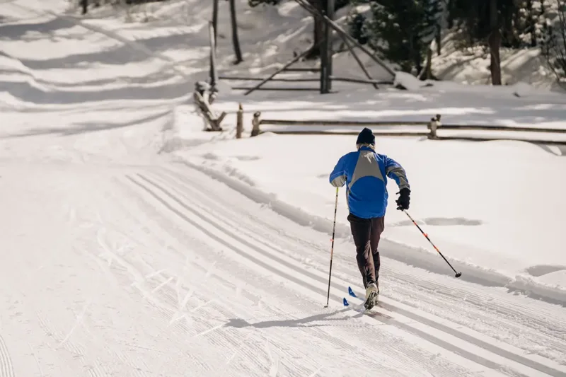 A nordic skier on an open trail.