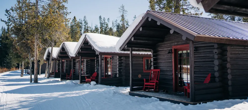 A row of cabins in snow.