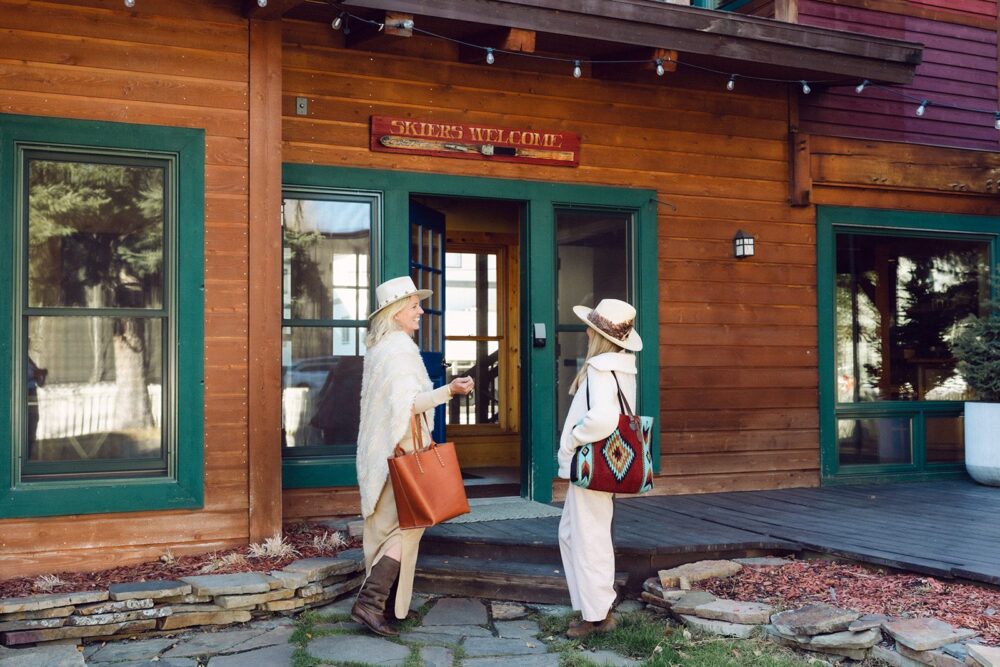 Two women walking into The Alpine House in Jackson, Wyoming.
